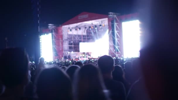 BOBRUISK, BELARUS - 6 DE JULIO DE 2018: una multitud de personas ven en el escenario durante el concierto de la banda Bi-2 en el B2 fest, video tomado con un efecto de velocidad de obturación más baja — Vídeos de Stock