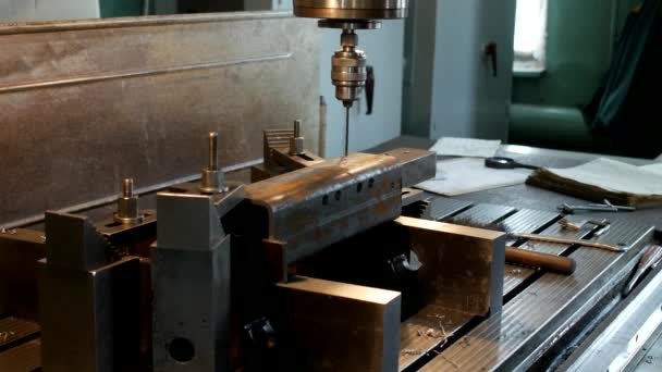 The drilling machine drills an opening in a metal workpiece, the manufacture of parts and assemblies, production and industry, machine-tool — Stock Video