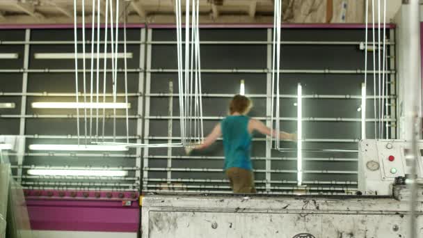 Production and manufacturing of double-glazed windows and PVC windows, a male worker installs glass in a production line for washing and drying glasses, worker — Stock Video