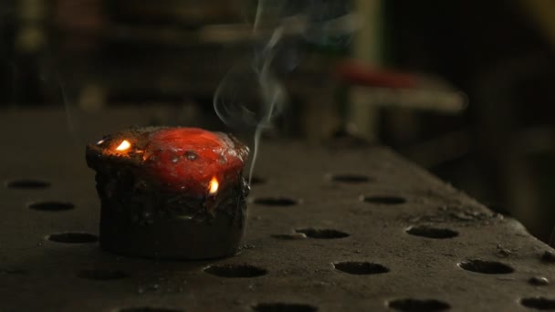 A red-hot piece of metal from which smoke comes, a close-up, a place for an inscription, slow-mo — Stock Video