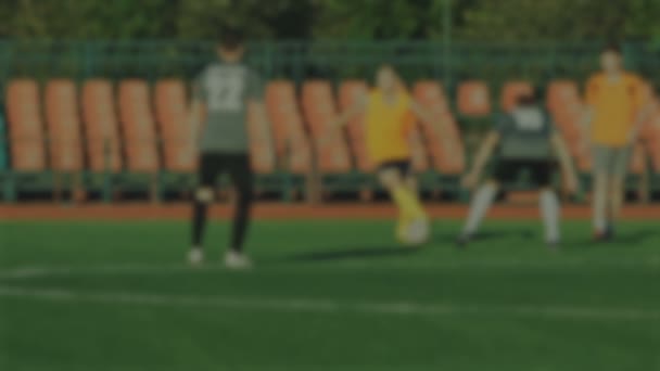 Jogadores de futebol correr e atirar uma bola, borrado para o fundo — Vídeo de Stock