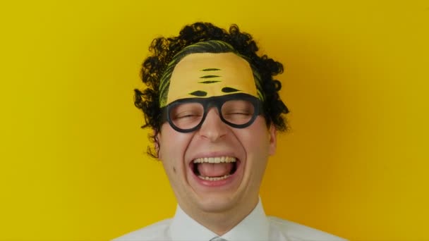 Portrait of young curly laughing man, funny and cheerfully human emotion, on yellow wall background — Stock Video