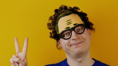 eğlenceli ve komik bir adam zafer tarafından iki parmak gösterir.