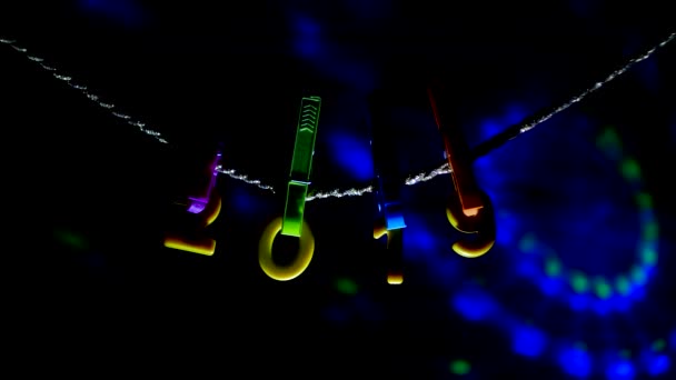 Figures 2019 hanging on clothespins and a rope, Christmas lights are on the background, the new year 2019, Christmas, colorful, Xmas — Stock Video