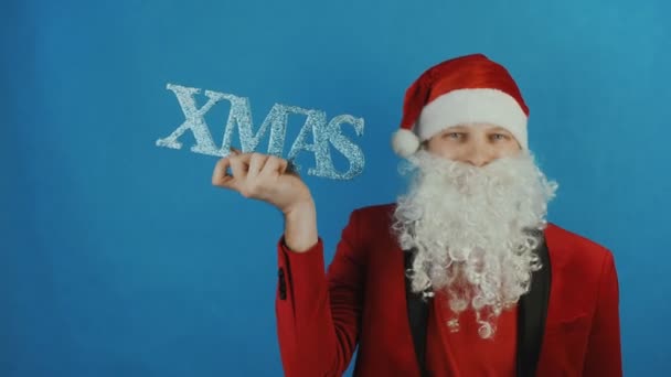 Nouvel An 2019, l'homme comme un Père Noël avec le texte de Noël, sur fond bleu — Video