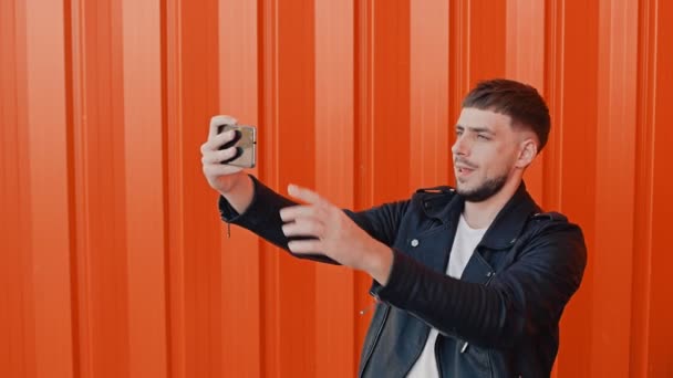 Blogger takes a selfie pictures on phone for his followers or subscribers in social networking service — Stock Video