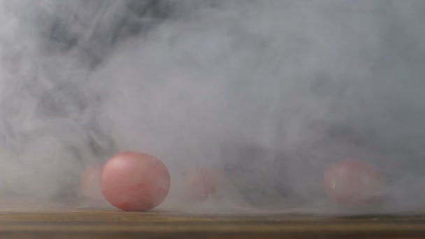 Tomates cherry o tomate rojo pequeño están sobre la mesa en el humo en cámara lenta — Vídeos de Stock