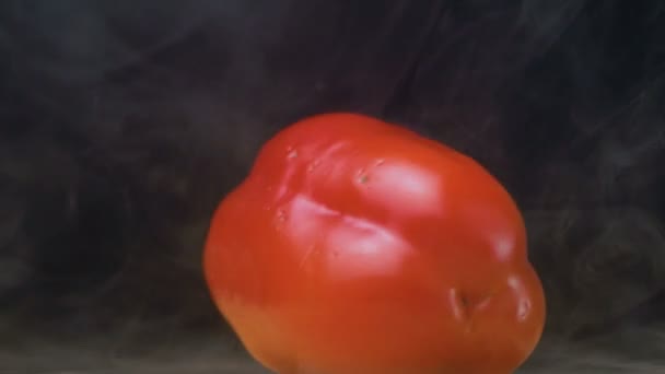 Red bell pepper or capsicum spin in smoke in slow motion, close up — Stock Video