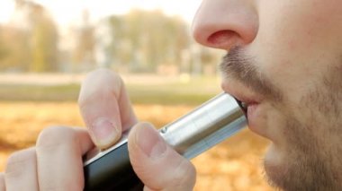 Acımasız ve şık beyaz adam sigara vape, yakın çekim, ağır çekim, elektronik sigara sakallı