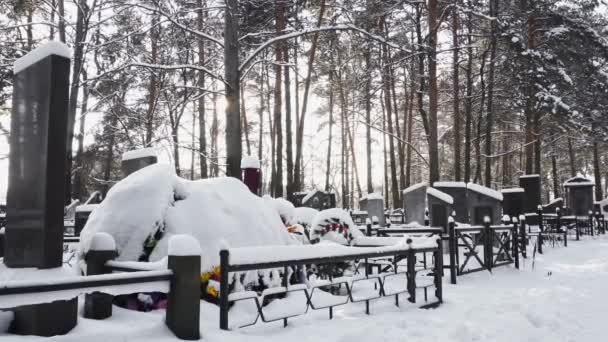 Tomba nevosa cristiana o ortodossa con corona funebre nel cimitero o cimitero in inverno nella foresta — Video Stock