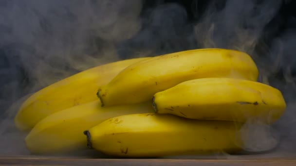 Ripe fresh Bunch of Cavendish bananas blown by smoke from behind, close up 4K — Stock Video