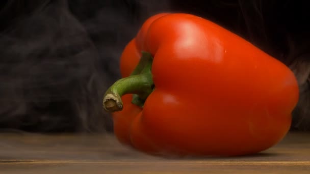 Sappige verse Bulgaarse rode peper op een zwarte achtergrond, ademt verse koelte en verdamping, close-up, slow motion, groenten — Stockvideo