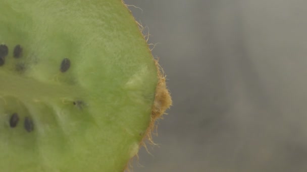 Macro or close up of juicy ripe fresh sliced Kiwifruit or Kiwi in smoke — Stock Video