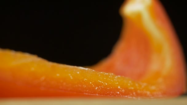 Macro of a piece of red sweet bell pepper or capsicum is on the table in smoke — Stock Video