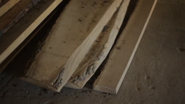 Wooden boards lie on the floor, timber or lumber is in the private workshop — Stock Video