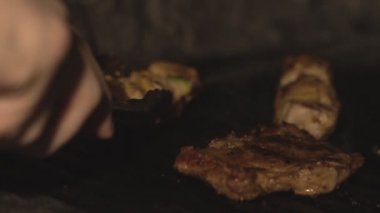 Geleneksel yerel yemeğiniyiyormuşsun Şaşlık veya şiş kebap pişmiş veya slowmo lokantada fırında ızgara. Domuz sığır eti parçaları üzerinde Barbekü yemek veya barbekü ızgara yavaş kafeler mutfak