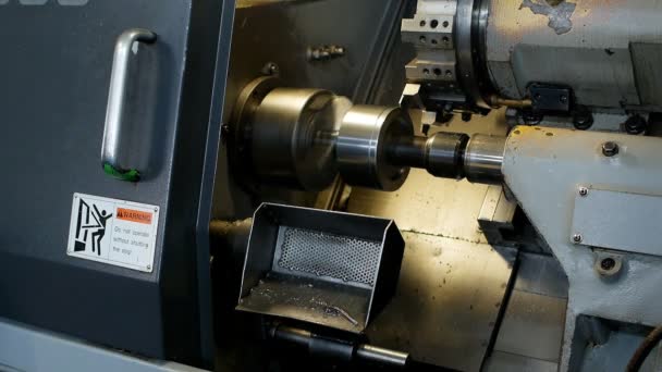 Modern lathe CNC grinds metal part for mechanical engineering, industry, metalworking — Stock Video