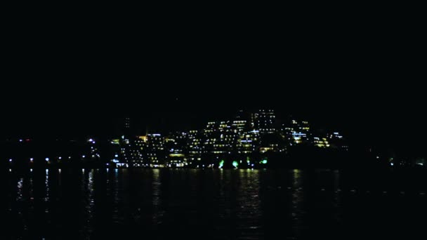 View of the night beach in tourist resort town Budva in the evening, beautiful landscape with the sea and island in Montenegro like a Italy or Croatia — Stock Video