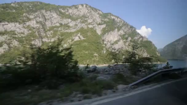 Turista de mano disparando paisaje de la naturaleza a través de la ventana del autobús en movimiento — Vídeos de Stock