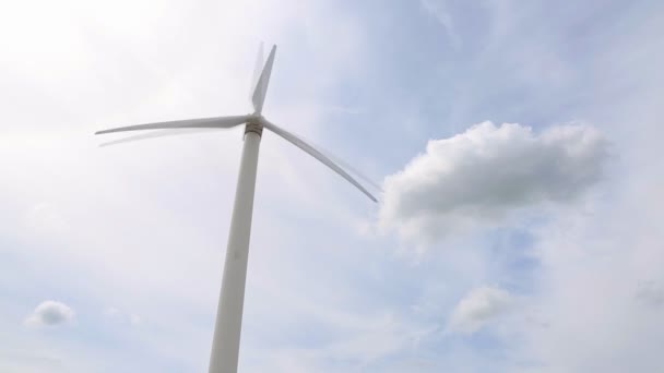 Generador eólico que genera electricidad debido a la rotación de las palas del rotor de la industria eólica, cielo azul, espacio de copia — Vídeos de Stock