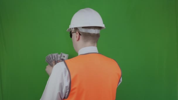 Engineer or builder counts money from the construction works. Bribe, graft. Chromakey. Chief with salary or wage. Corrupt Boss received american dollars for the completion of the building process — Stock Video