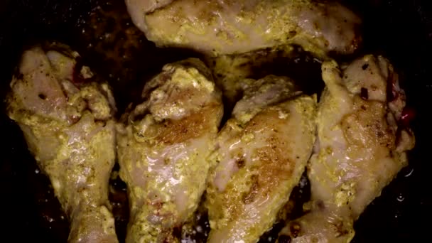 Fatty fried chicken fried with mayonnaise and spices in a pan, junk food. Vascular clogging with cholesterol, atherosclerosis, background, close-up — Stock Video