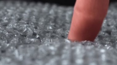 Parmak kompresi hava ambalajlı film plastik ambalaj malzemesi, makro baloncukları yırtar. Sinir sistemi konsepti. Dokunsal bir eğlence türüdür. Zevkle sakinleştirici etki. Zevk ver. Memnuniyet