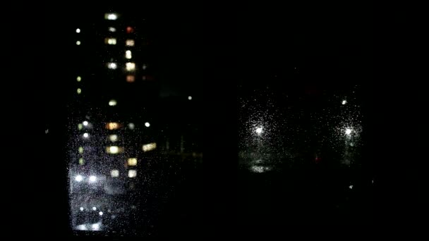 창문에 빗방울이 보이고, 집의 창문에서 거리까지, 배경을 바라본다. 랜턴과 자동차 조명 문자를 위한 복사 공간, 밤 — 비디오