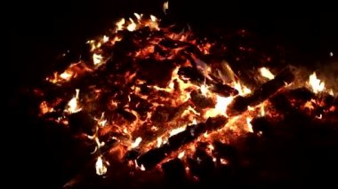 Siyah arka plandaki bir yangından çıkan bir sürü sıcak kömür...