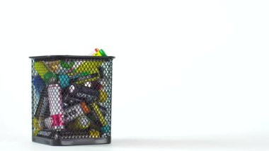 BOBRUISK, BELARUS 10.08.2020: Kullanılmış bataryalar beyaz arka planda bir çöp kutusuna düşer. Pil geri dönüşüm kavramı, metin için kopyalama alanı