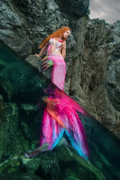 Beautiful mermaid with long tail on sea shore — Stock Photo, Image