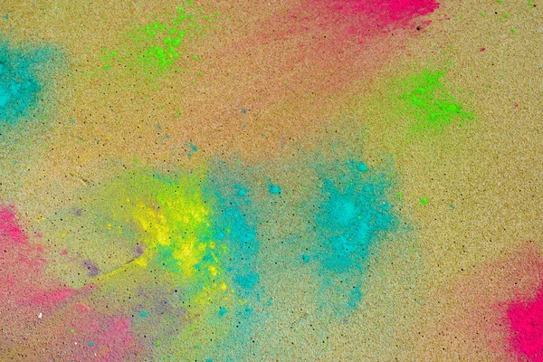 Holi paint on sea sand — Stock Photo, Image