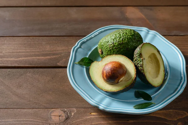 Авокадо в тарелке на столе — стоковое фото