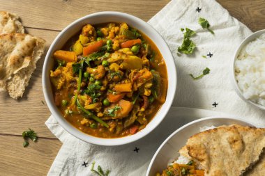 Homemade Spicy Vegan Vegetable Curry with Rice and Naan clipart