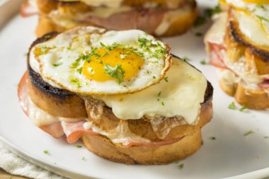 Homemade French Croque Madame Sandwich with Ham and Cheese clipart