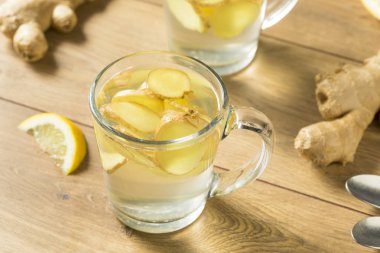 Ev yapımı taze zencefil çay limon bir kupa ile
