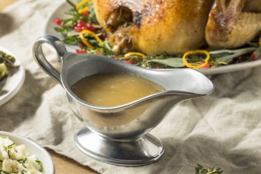 Dark Homemade Turkey Gravy for Thanksgiving Dinner clipart