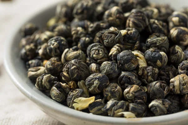 Dried Organic Jasmine Pearl Tea in a Bowl