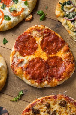 Gurme ev yapımı çeşitli ahşap pizza Pepperoni fesleğen ve peynir ile ateş