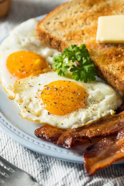 Homemade Sunnyside Eggs Breakfast with Toast and Bacon