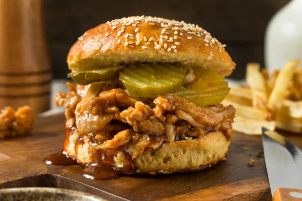 Homemade BBQ Pulled Chicken Sandwich with PIckles and Fries
