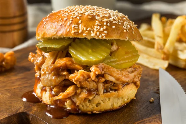 Homemade BBQ Pulled Chicken Sandwich with PIckles and Fries