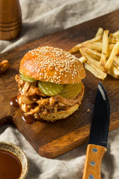 Homemade BBQ Pulled Chicken Sandwich with PIckles and Fries