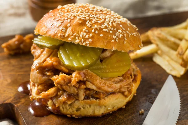Homemade BBQ Pulled Chicken Sandwich with PIckles and Fries
