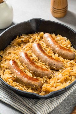 Homemade Savory Bratwurst and Sauerkraut in a Cast Iron Pan