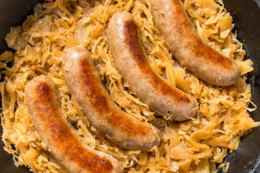 Homemade Savory Bratwurst and Sauerkraut in a Cast Iron Pan