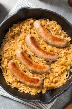 Homemade Savory Bratwurst and Sauerkraut in a Cast Iron Pan