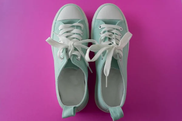 A pair of sneakers on a Purple Background