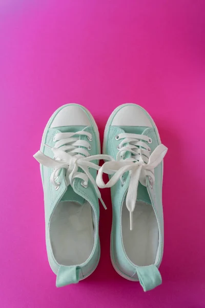 A pair of sneakers on a Purple Background