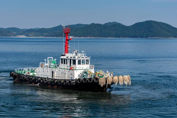 The small tug vessel in the sea